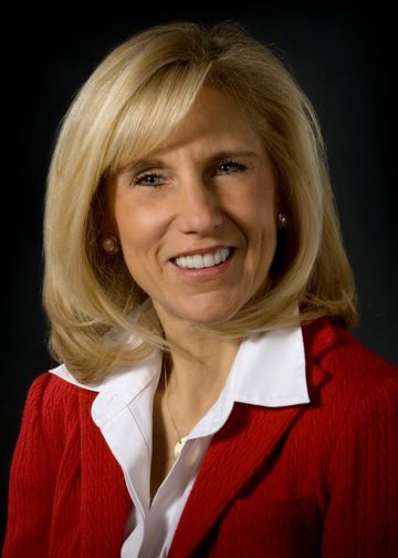 Merryl Siegel wearing a red suit jacket